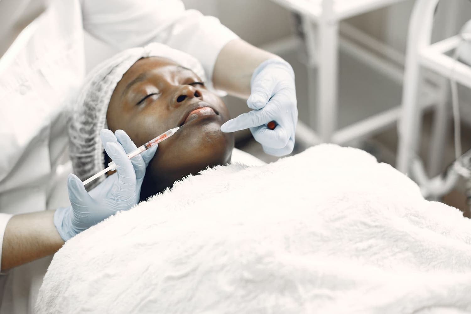 Aesthetic practitioner giving an injectable treatment in a CQC-registered cosmetic clinic